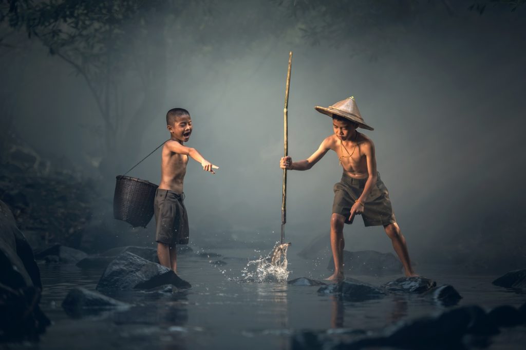 Local Boys are fishing on a small pond For their meal